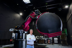 Prof. Dr. Heinrich Bülthoff in front of the CyberMotion Simulator.